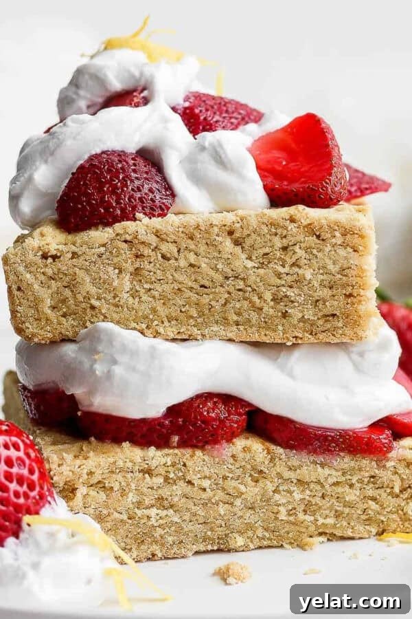 Gluten free strawberry shortcake on a plate topped with whipped cream and strawberries