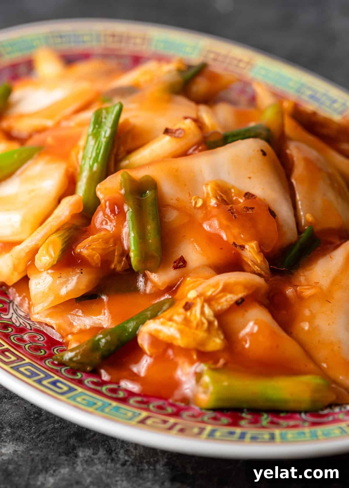 closeup: hot and sour cabbage with green onion and red pepper flakes