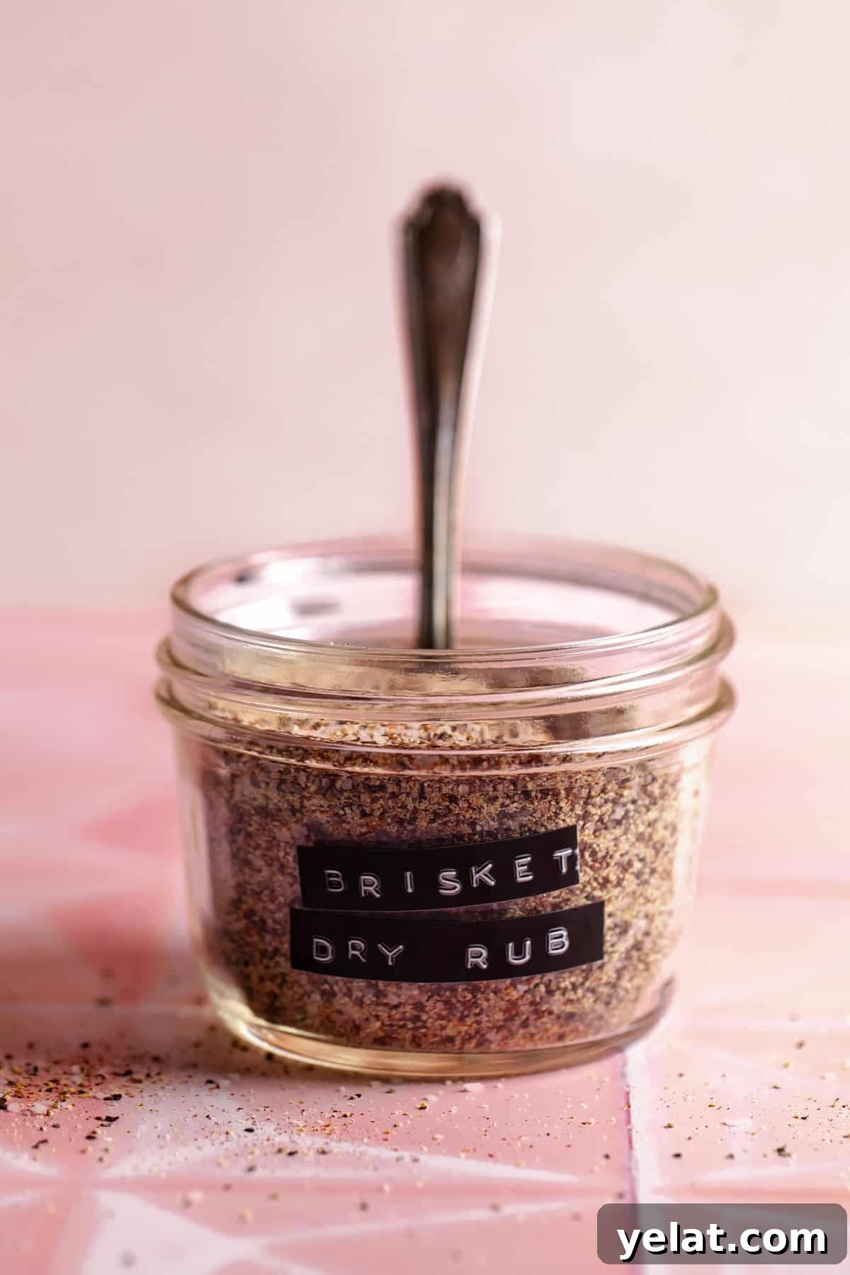 Ultimate Texas-Style Brisket Rub Recipe for Smoky Flavor 2 Small glass jar filled with spice mix and a label of Brisket Dry Rub.