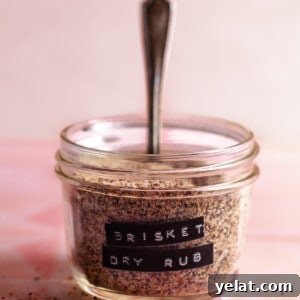 Ultimate Texas-Style Brisket Rub Recipe for Smoky Flavor 10 Small glass jar filled with spice mix and a label of Brisket Dry Rub.