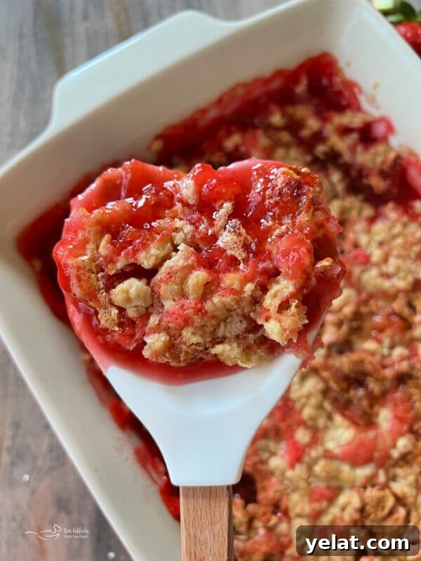 Strawberry Rhubarb Crisp with Buttery Oat Topping 4 Close up view of dessert on spoon