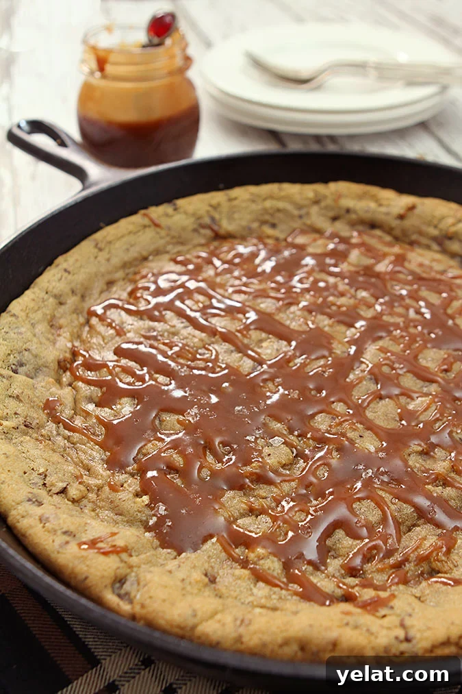 Chocolate Chip Skillet Cookie with Pecans, Bourbon Caramel Sauce Chocolate Chip Skillet Cookie with Pecans, Bourbon Caramel Sauce in a Cast Iron Pan