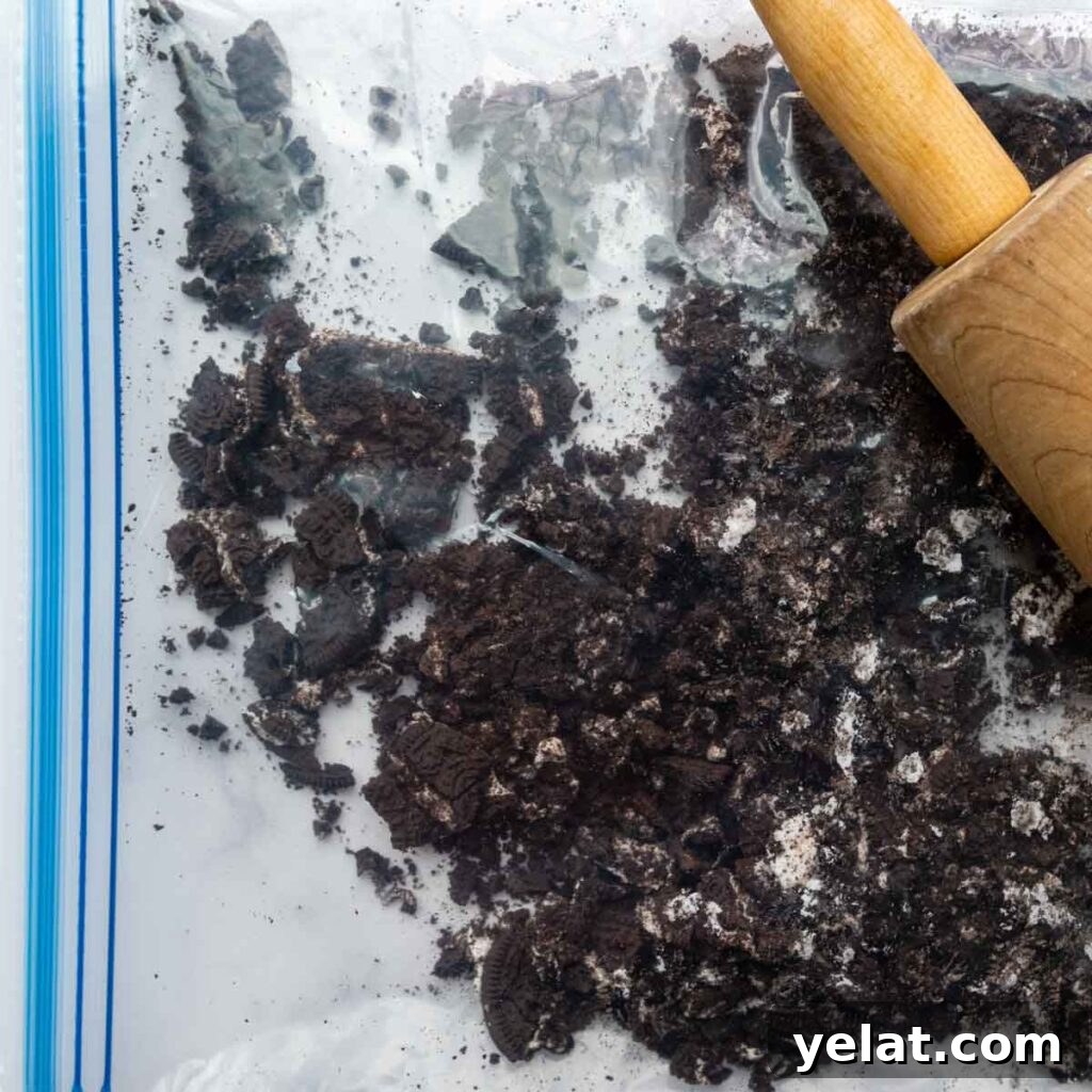 Ultra-Cream Gluten-Free Oreo Cheesecake Recipe 6 a rolling pin crushing oreos