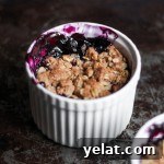 Two ramekins with blueberry crisp.
