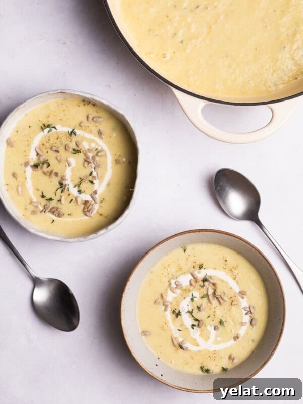 Parsnip soup with sunflower seeds served in bowls.