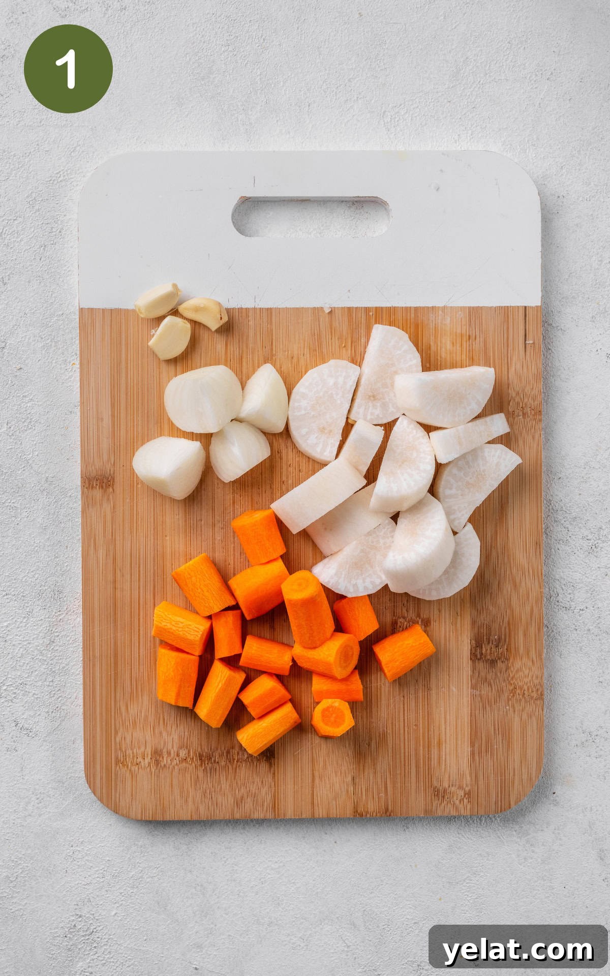Creamy Carrot and Parsnip Soup Recipe for Cozy Meals 4 chopped carrots, parsnip and onions on a wooden cutting board.