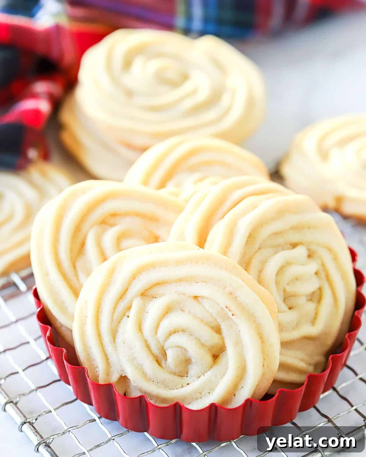 Classic Old-Fashioned Butter Cookies Recipe 7 Baked butter cookies in a red bowl.