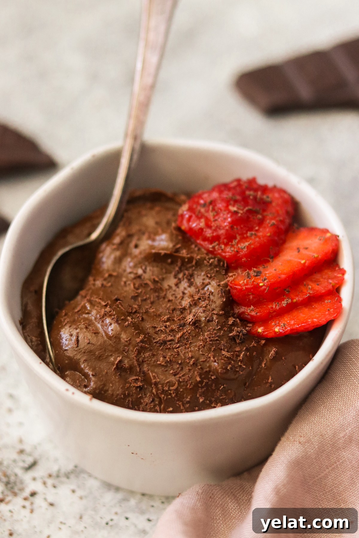 Creamy Avocado Chocolate Pudding Even Picky Eaters Love 5 close up shot of creamy sweet potato chocolate pudding with strawberries and shaved chocolate