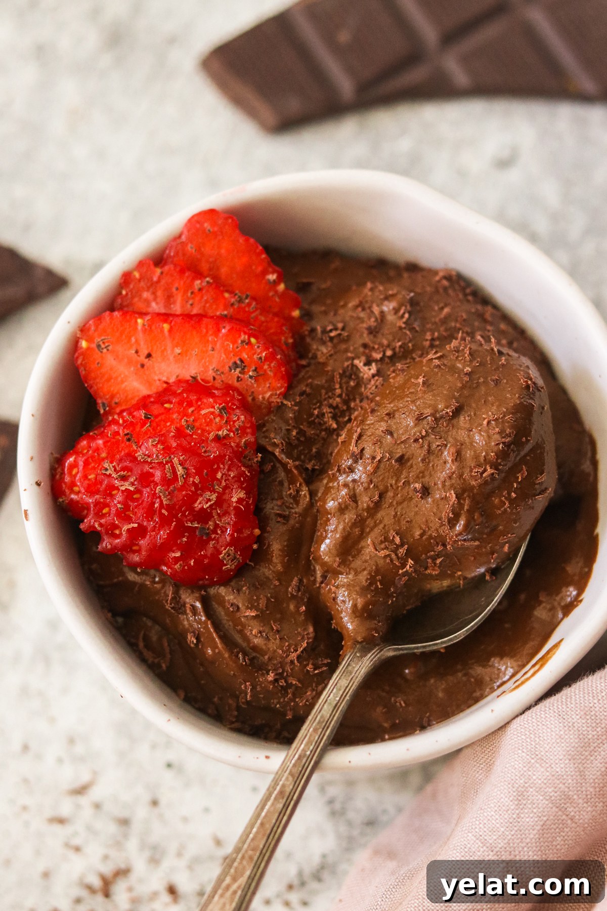 Creamy Avocado Chocolate Pudding Even Picky Eaters Love 6 an overhead shot of chocolate pudding with a spoonful of it getting lifted from the bowl