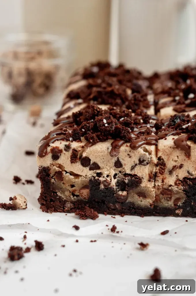 Cookie Dough Brownies with Gluten-Free & Dairy-Free Options 6 Dark brown fudgy brownies with chunks of edible cookie dough and topped with a thick layer of cookie dough on top.
