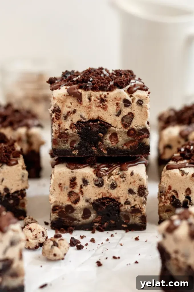 Cookie Dough Brownies with Gluten-Free & Dairy-Free Options 7 Dark brown fudgy brownies with chunks of edible cookie dough and topped with a thick layer of cookie dough on top.