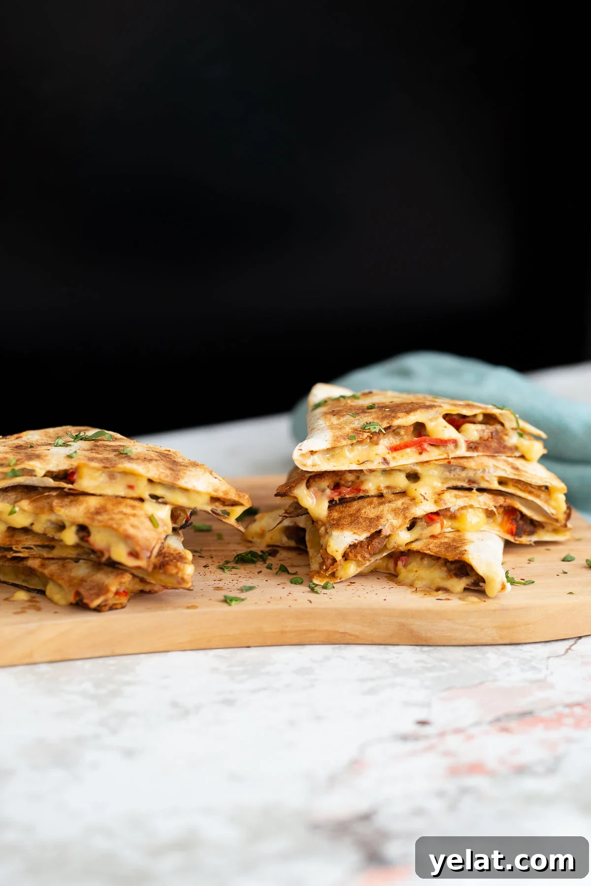 walnut taco meat side view of vegan quesadillas filled with vegan walnut taco meat, bell pepper and melted cheese