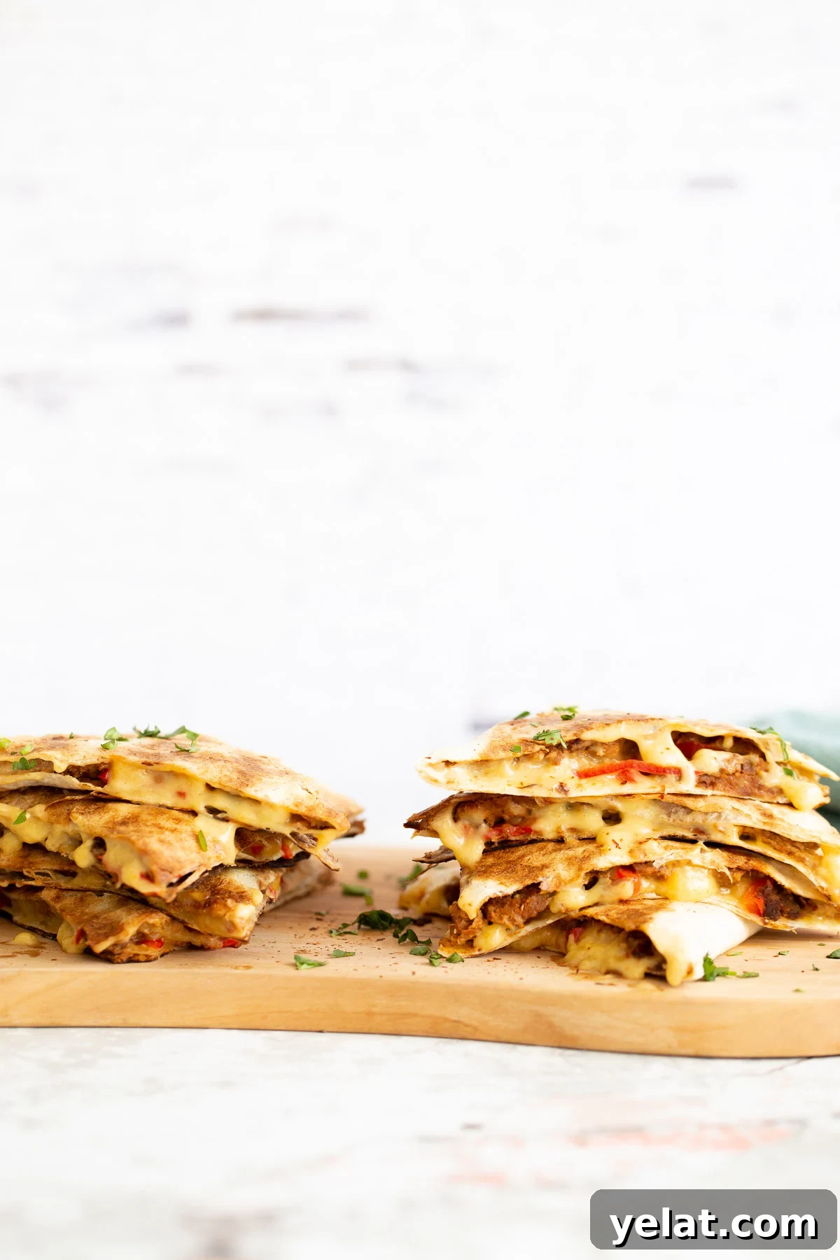 walnut taco meat two stacks of quesadillas filled with vegan walnut taco meat on a chopping board