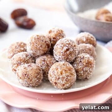 Salted Caramel Bliss Balls, sitting on a white plate on top of a pink plate and tea towel.