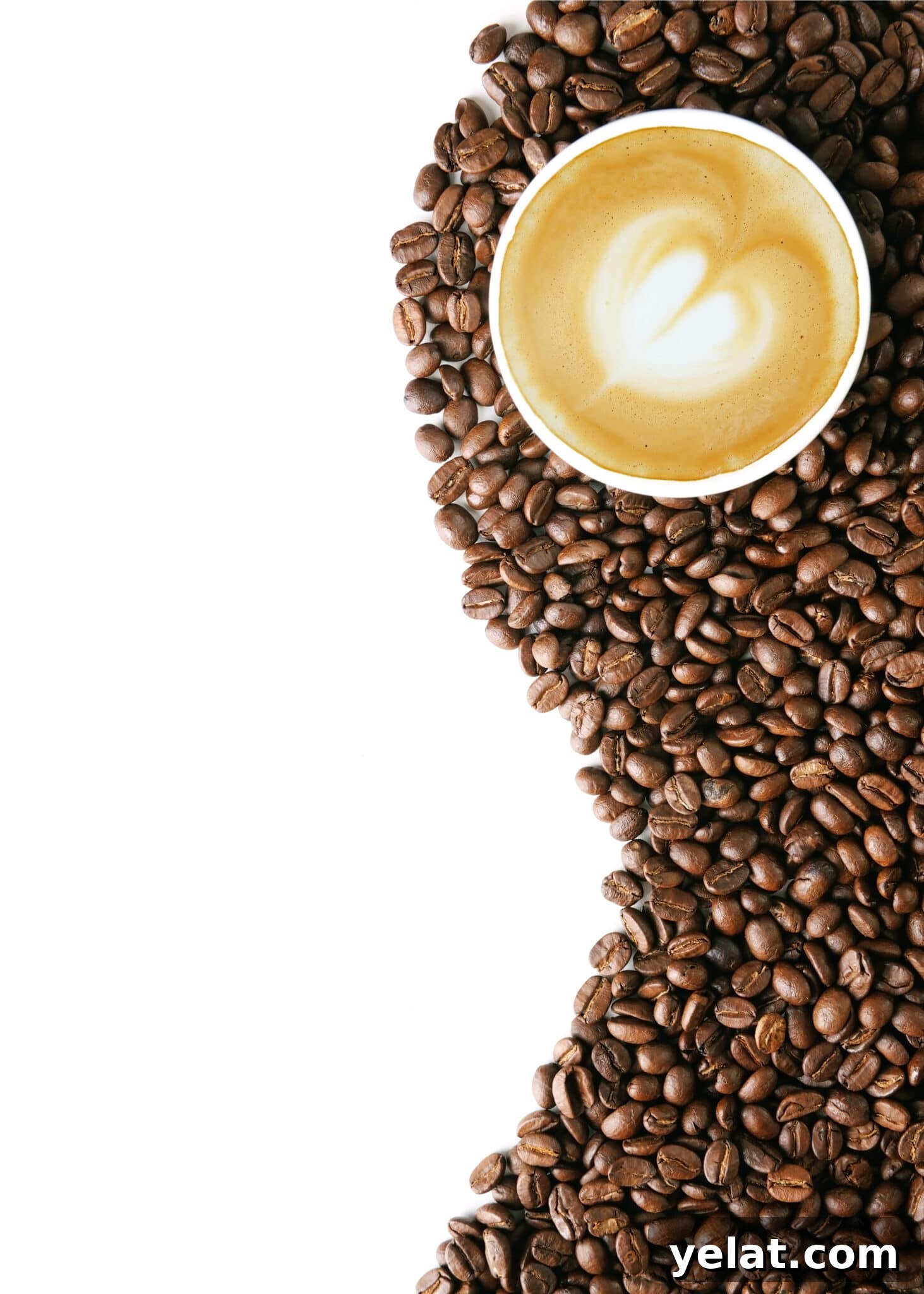 Low-Carb Pantry Essentials for Baking: Flour Substitutes & Staples 18 Coffee beans on a bright white table top with a cup of coffee with a white foam heart in the center.