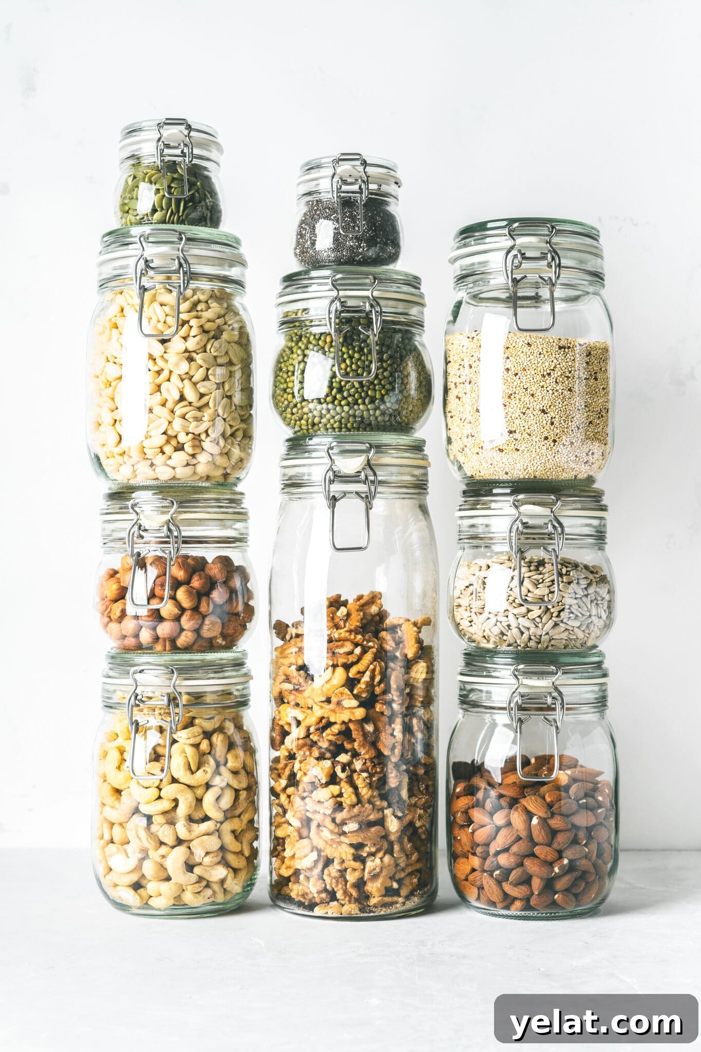 Low-Carb Pantry Essentials for Baking: Flour Substitutes & Staples 4 Glass jars stacked filled with low carb panty essential nuts and seeds