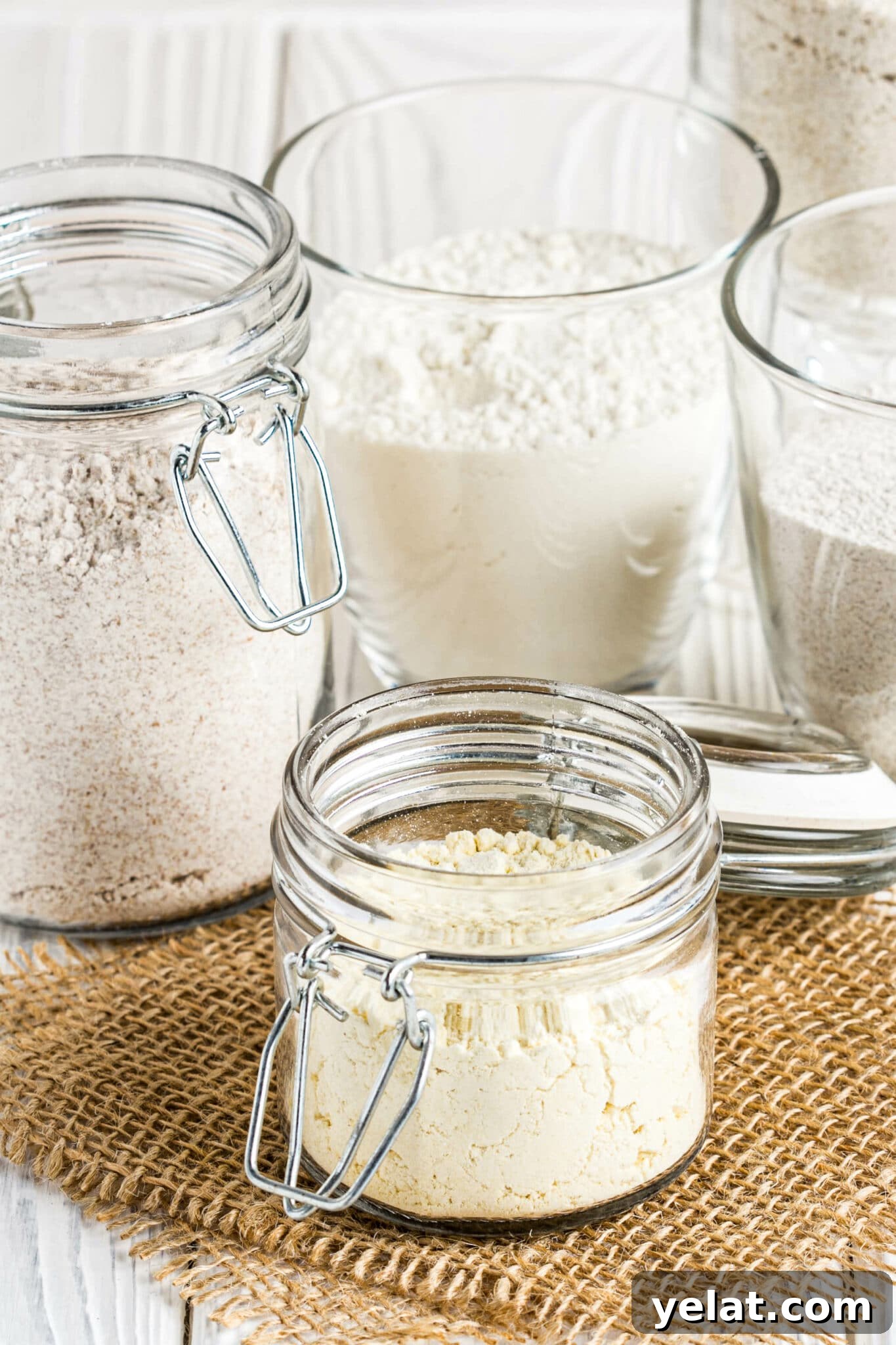 Low-Carb Pantry Essentials for Baking: Flour Substitutes & Staples 5 Different low carb flour in glass jars, almond, coconut