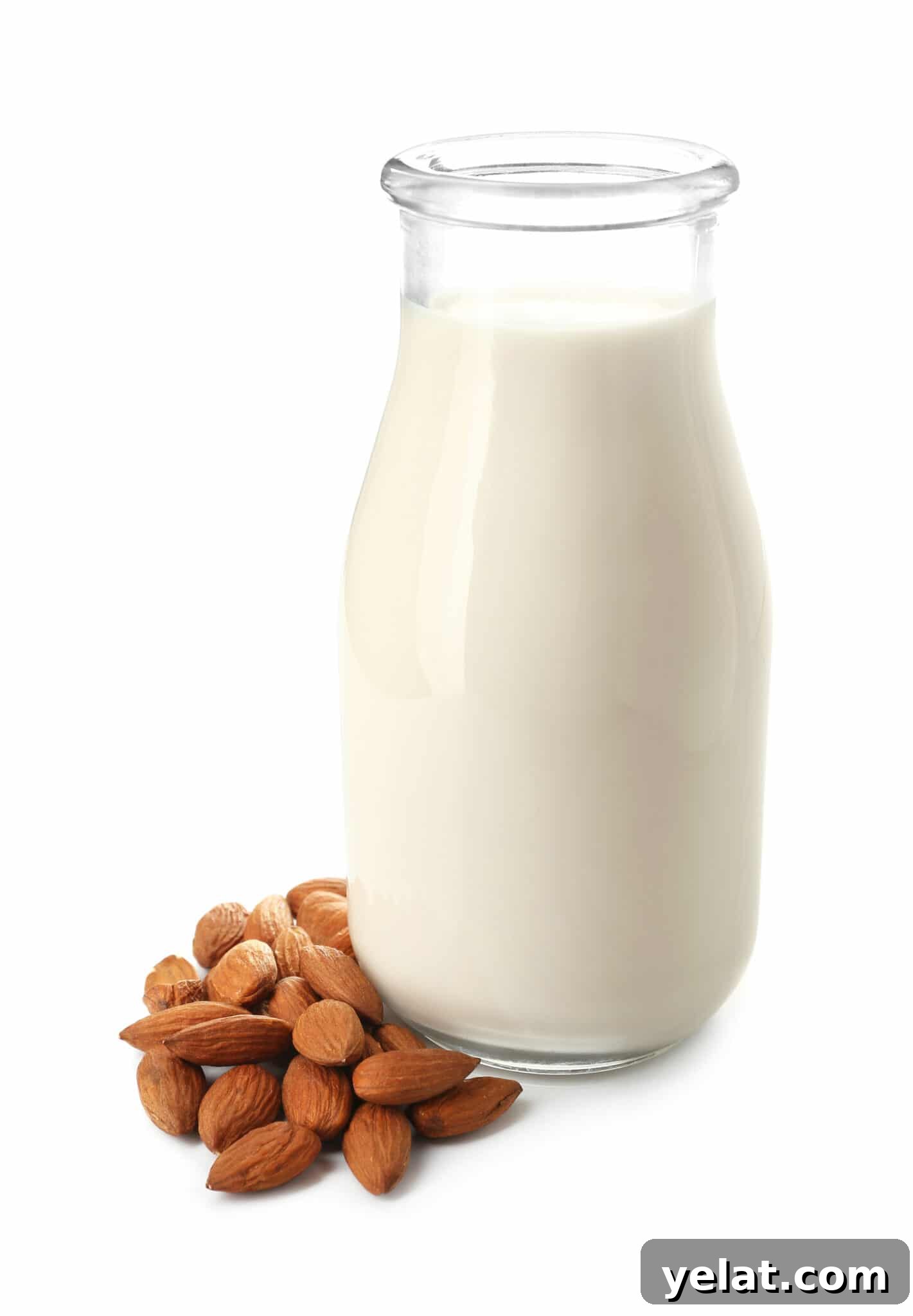 Low-Carb Pantry Essentials for Baking: Flour Substitutes & Staples 9 A tall glass bottle of almond milk, with a small pile of almonds beside it.