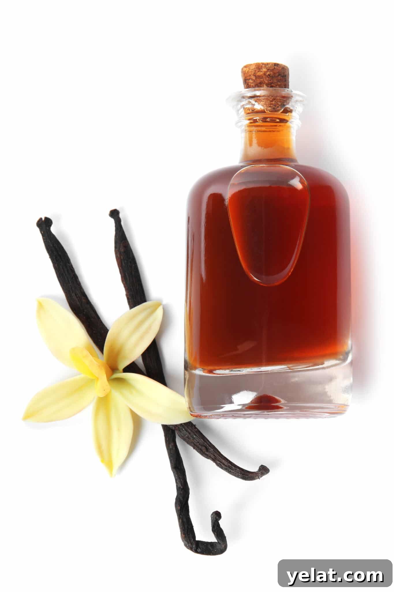 Low-Carb Pantry Essentials for Baking: Flour Substitutes & Staples 10 Vanilla beans and flower next to a small bottle of vanilla with a cork stopper.