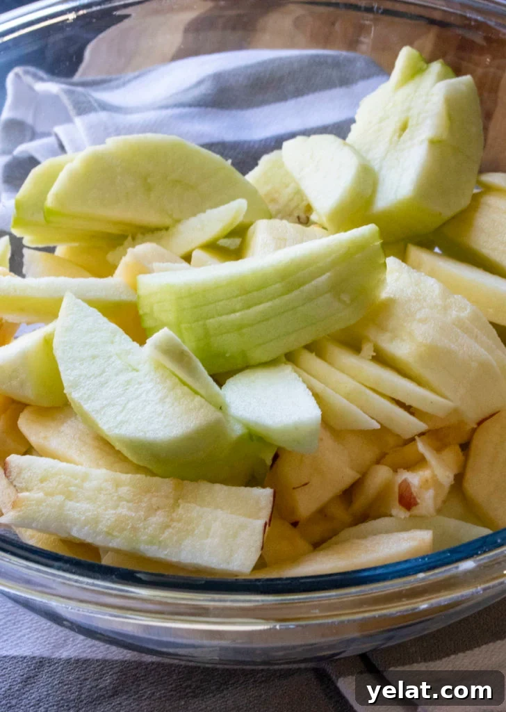 sliced apples in a mixing bowl