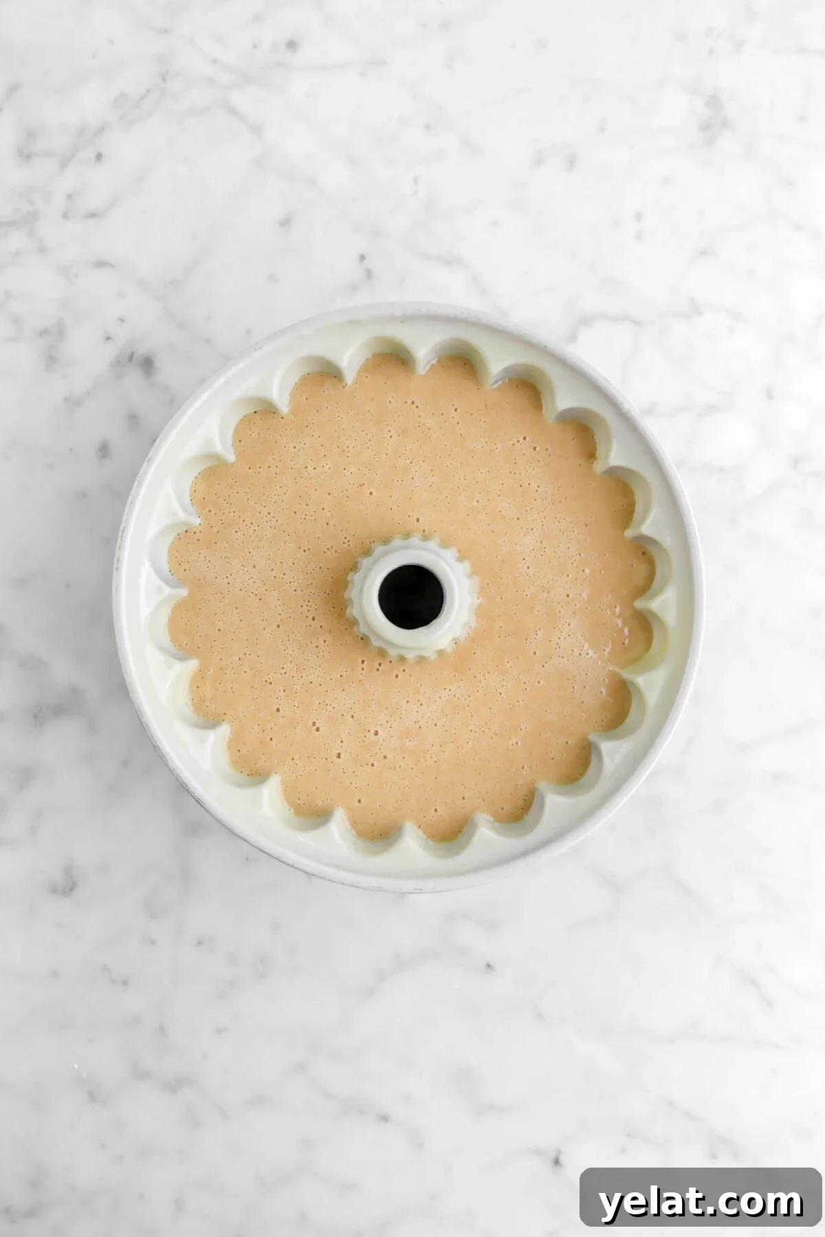Spiced Apple Cider Bourbon Bundt Cake Recipe for Fall Desserts 10 cake batter in greased bundt pan.