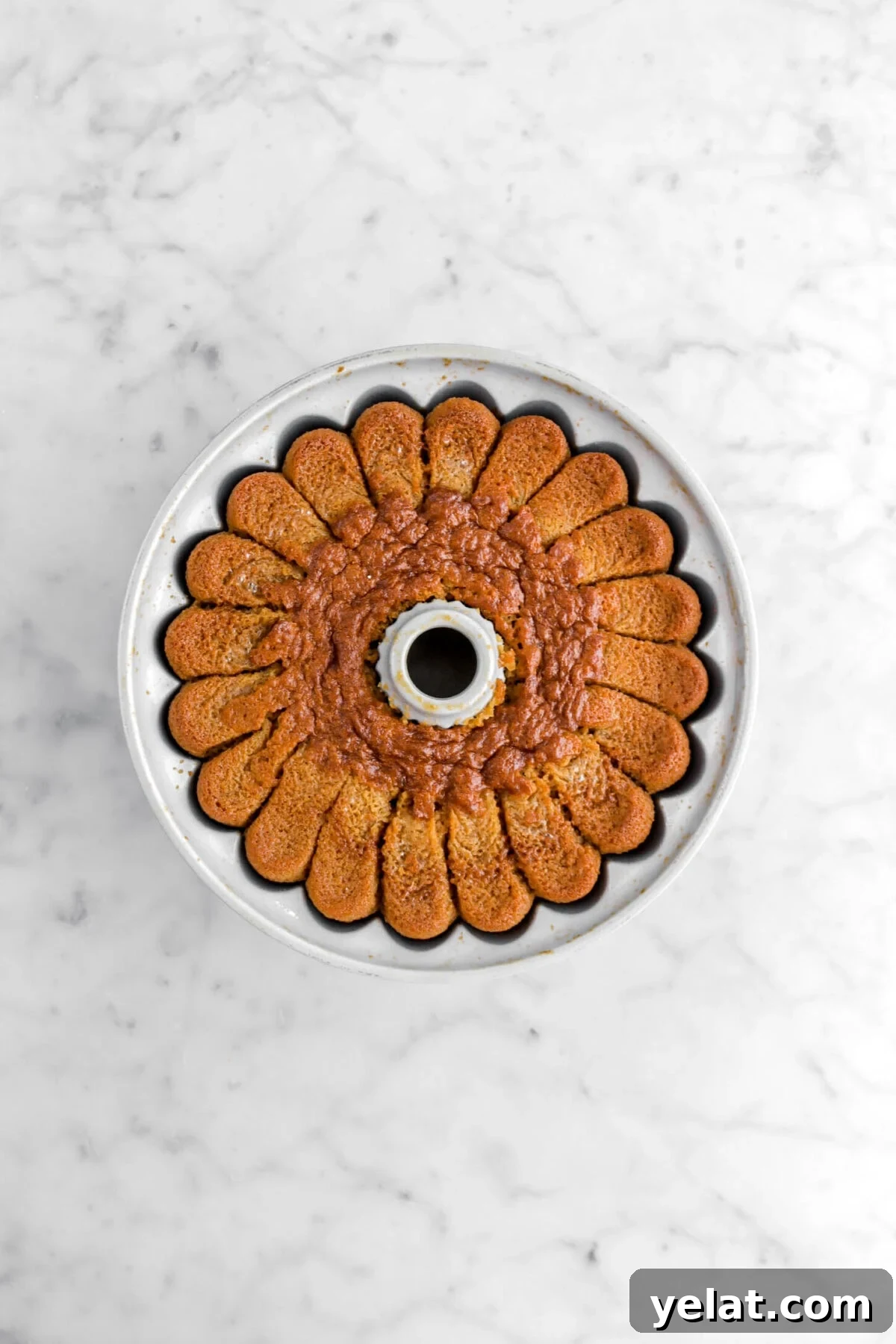 Spiced Apple Cider Bourbon Bundt Cake Recipe for Fall Desserts 11 baked bundt cake on marble surface.