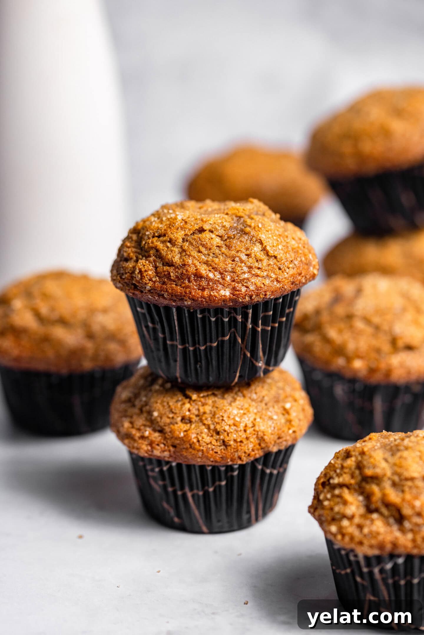 Moist Small-Batch Banana Muffins Recipe for Perfect Breakfast 4 Banana muffins stacked on top of each other