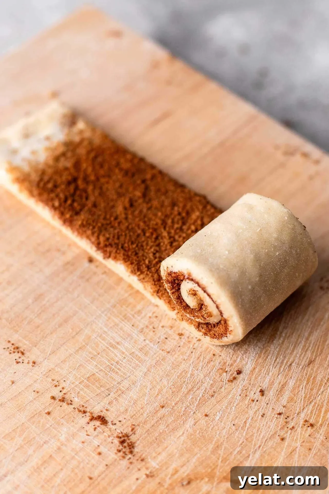 Cinnamon Rolls for Two: Small-Batch Recipe for Soft, Gooey Treats 4 small batch cinnamon rolls strip of dough partially rolled up into a log