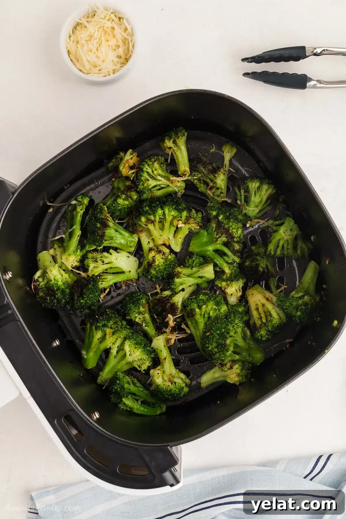 Crispy Air Fryer Frozen Broccoli: Quick 15-Minute Recipe 2 Broccoli in the air fryer basket.