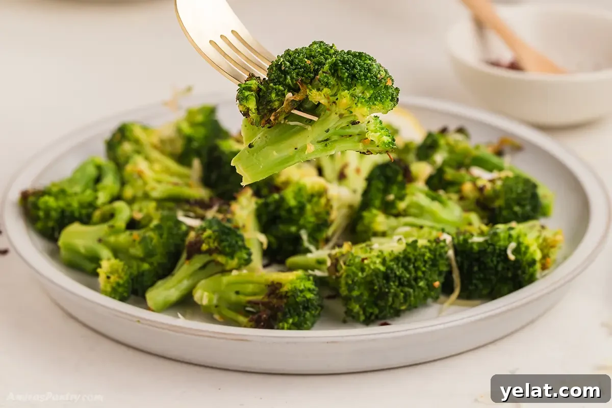 Crispy Air Fryer Frozen Broccoli: Quick 15-Minute Recipe 5 A fork with a piece of air fried broccoli.