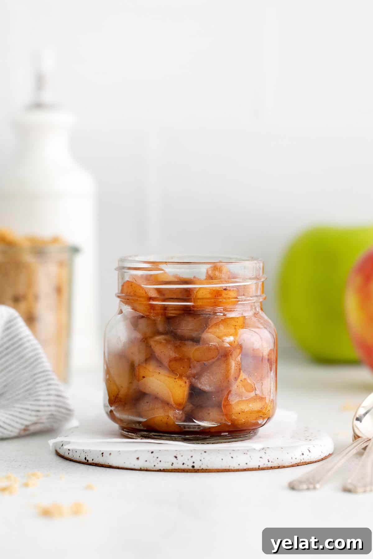 A jar of apple compote on a countertop