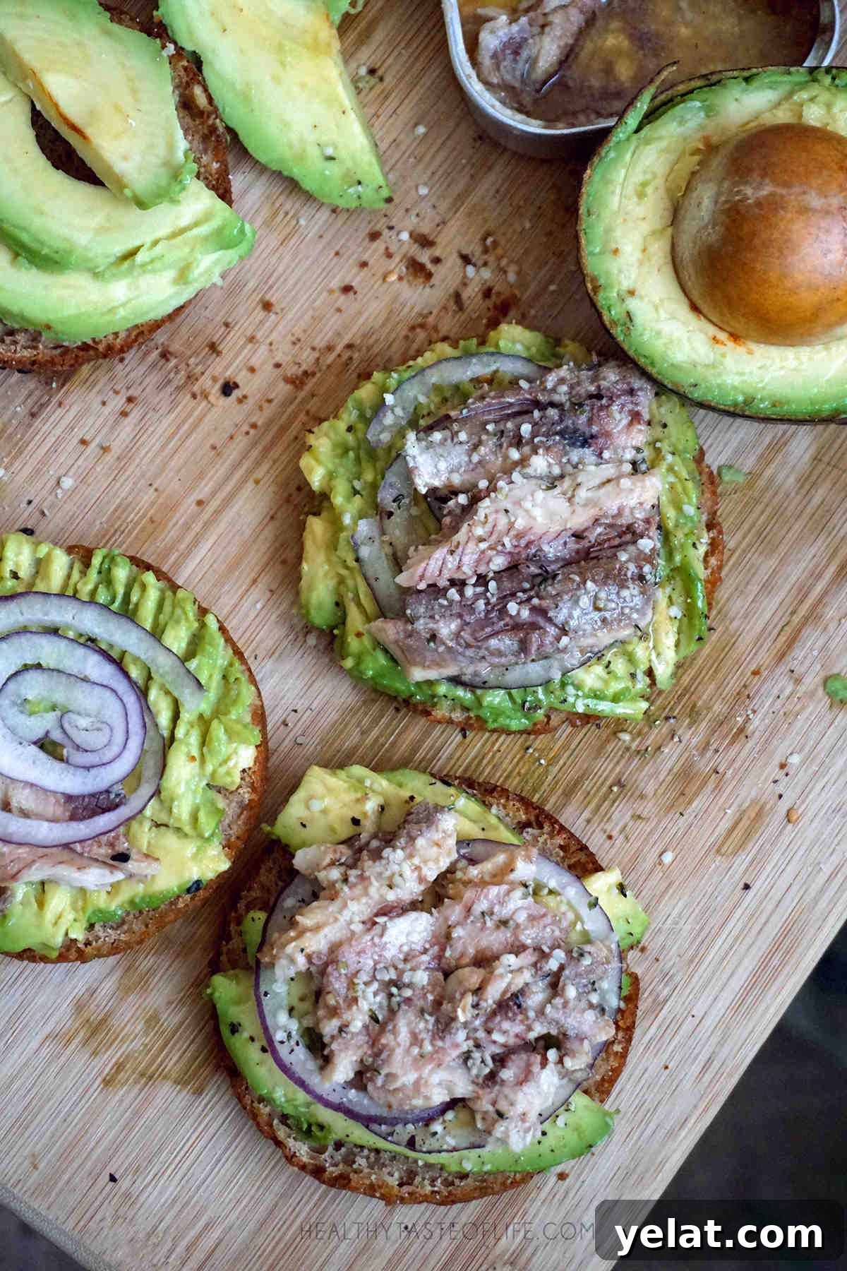 Savory Gluten- and Dairy-Free Breakfast Ideas Without Sugar 3 Gluten free dairy free avocado toast made with homemade gluten free buns topped with sardines, red onion and finished with hemp seeds.