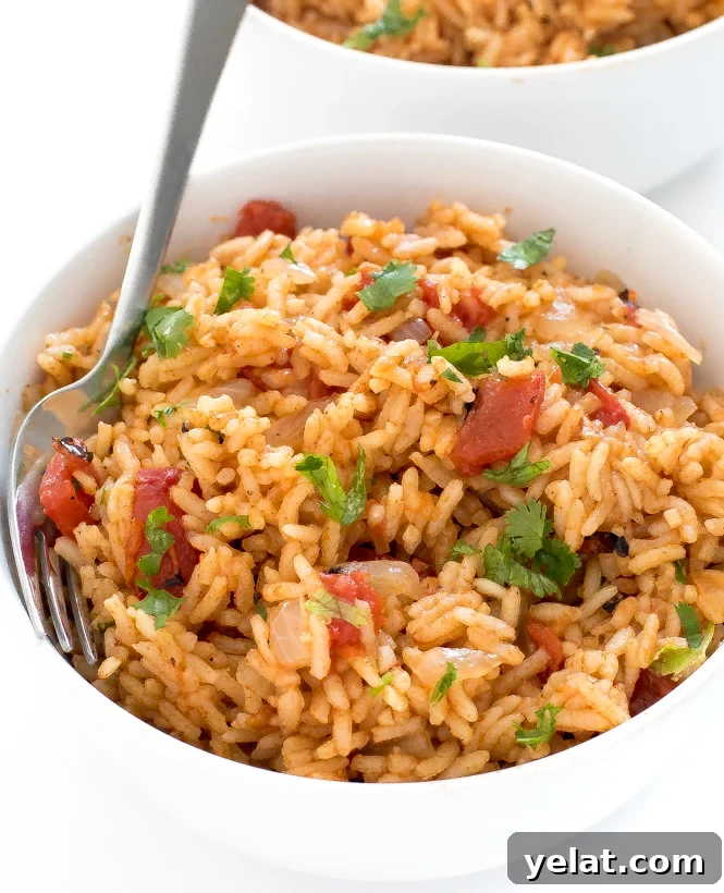 Instant pot rice in a white bowl with a fork. 