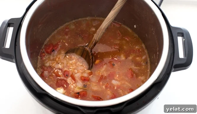 All ingredients for Spanish rice mixed together in the instant pot. 