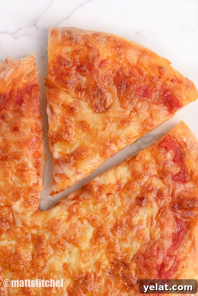 Slice of homemade low calorie pizza with fat reduced cheese topping
