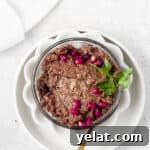 Silky Beef Liver Pâté Recipe for Entertaining and Apps 12 Beef liver pate in a white bowl with a spoon.