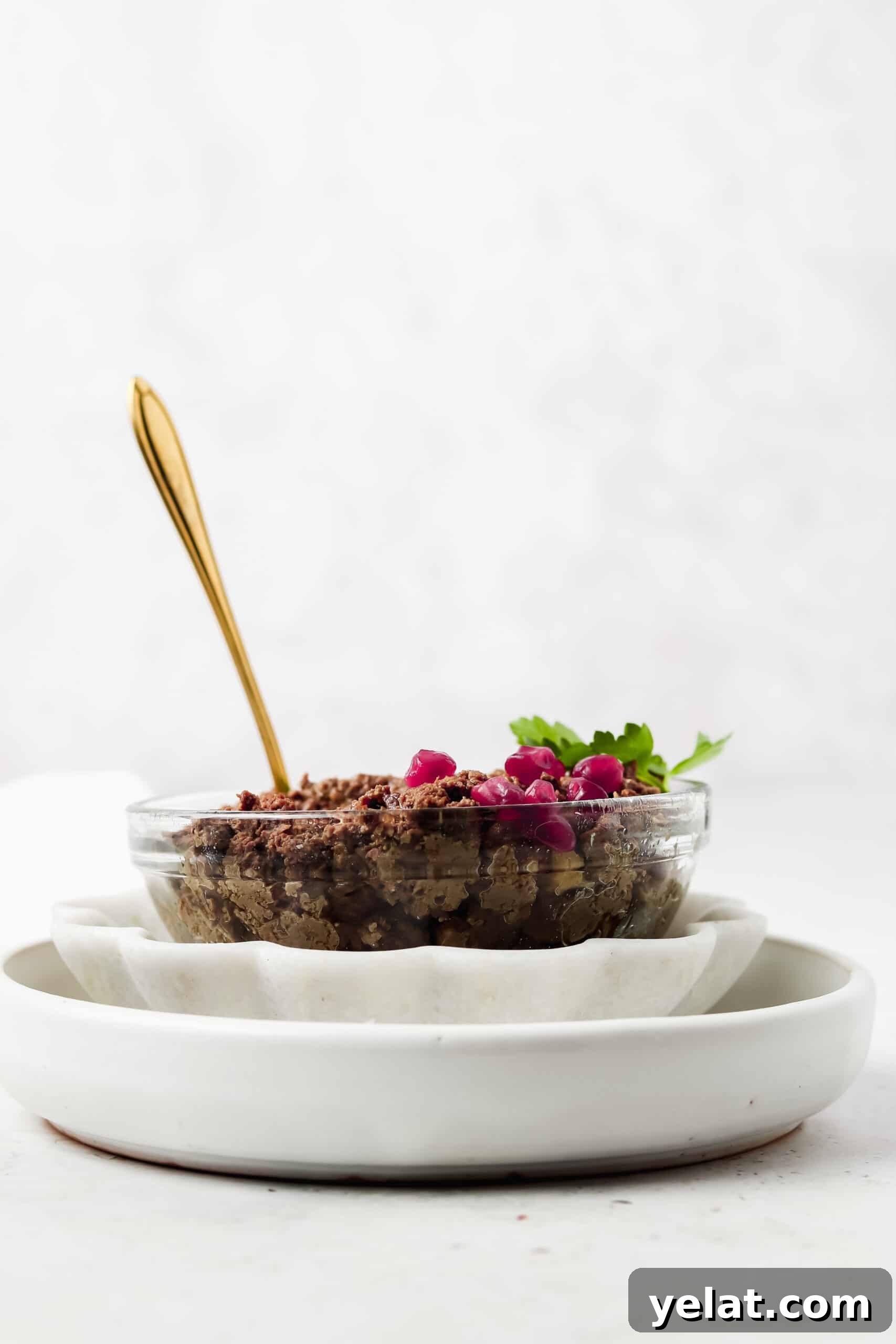 Silky Beef Liver Pâté Recipe for Entertaining and Apps 7 Beef liver pate in a bowl with a spoon hanging out of it.