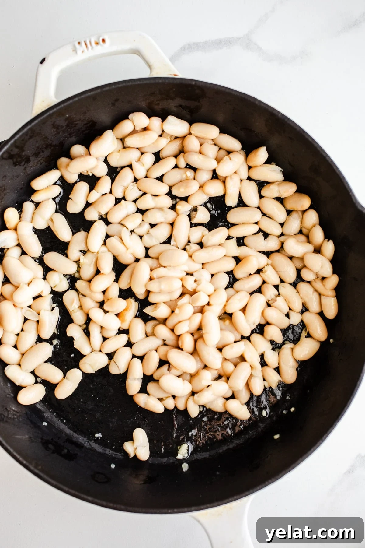 Creamy White Bean Pasta with Garlic and Herbs 5 White beans in a skillet.