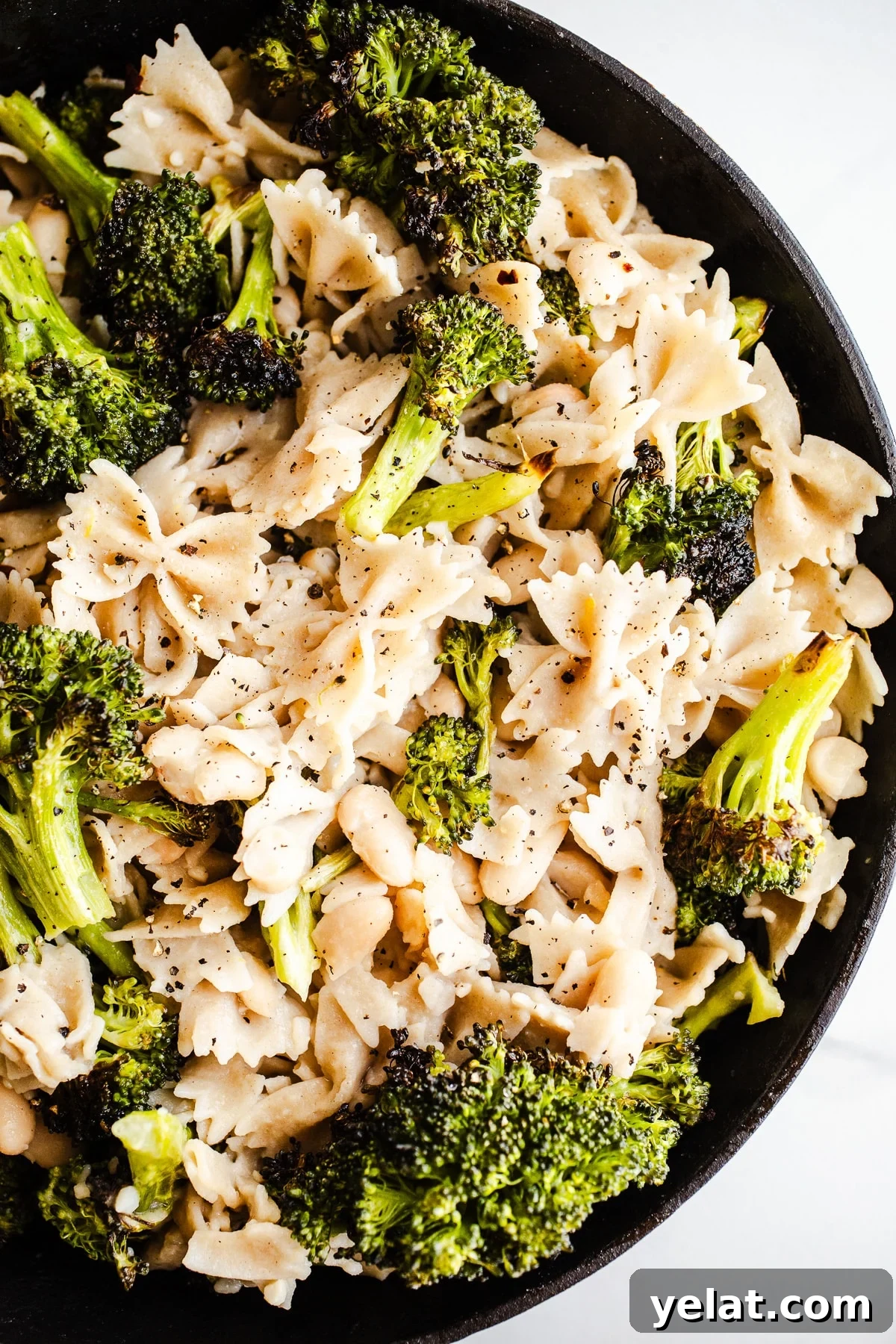 Creamy White Bean Pasta with Garlic and Herbs 7 Roasted broccoli, pasta, and beans in a skillet.