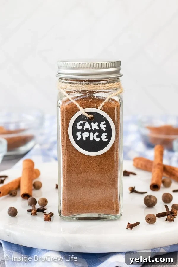 A small spice jar with a black label filled with cake spice.