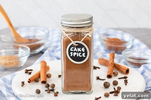 A glass jar with a metal lid filled with cake spice.