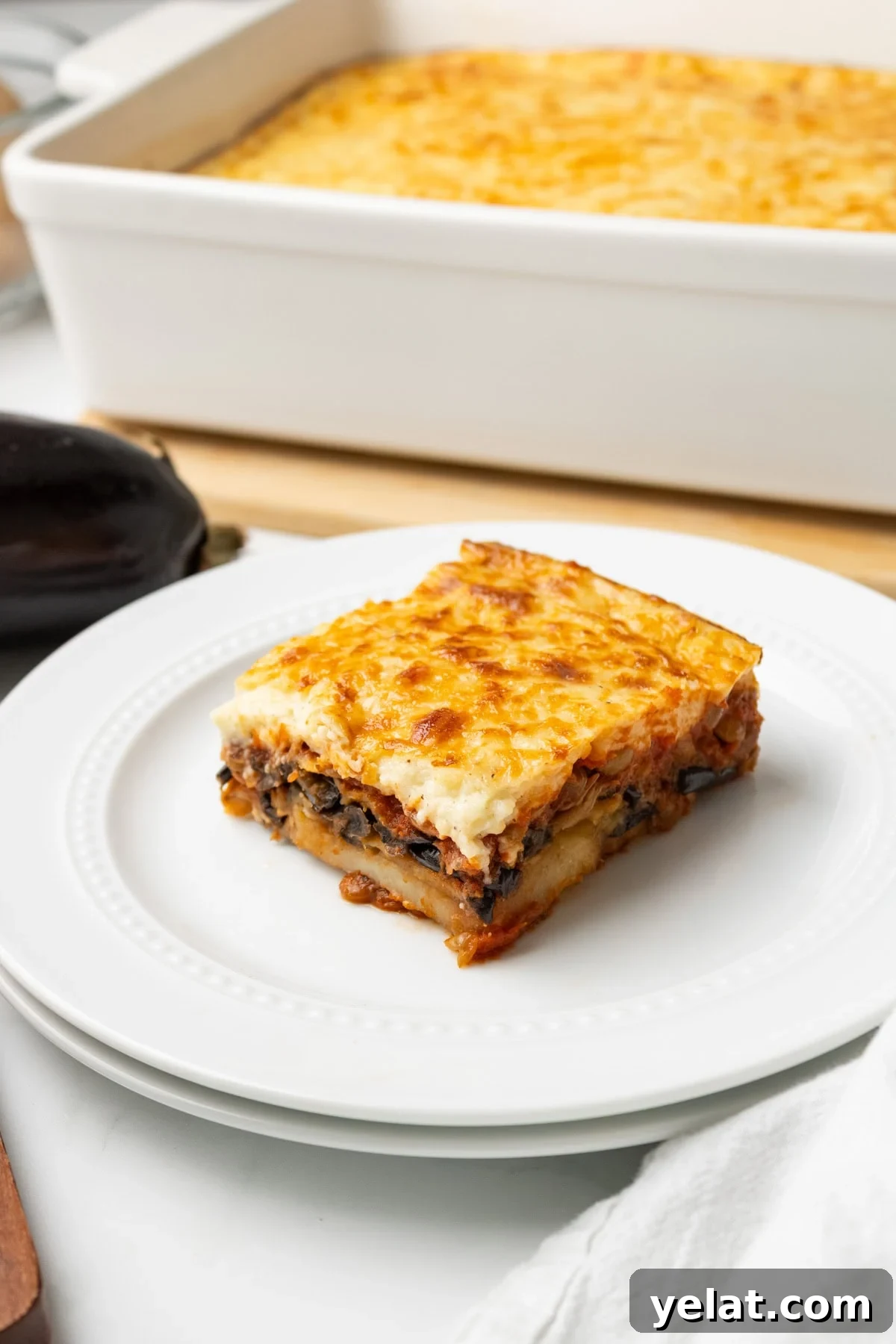 A close up image of vegetarian moussaka served on a plate.