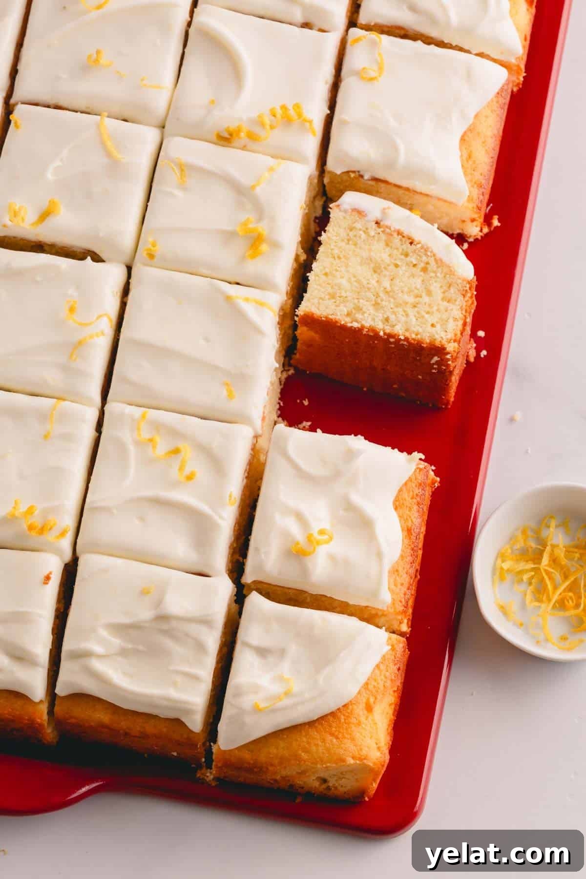 Lemon Sheet Cake Recipe: Zesty, Moist Lemon Cake for Large Groups 3 Lemon sheet cake with lemon cream cheese frosting sliced into squares.