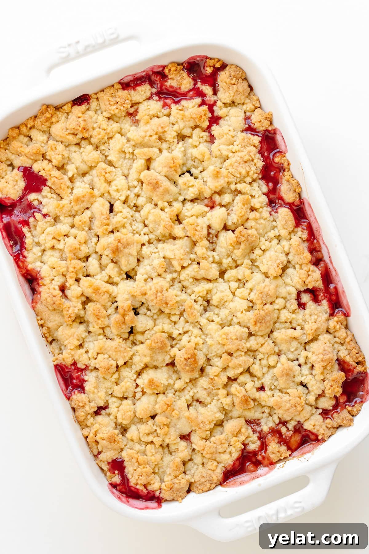 Rustic Plum & Apple Crumble Recipe for Fall Baking 8 A baked plum and apple crumble in a white baking dish.