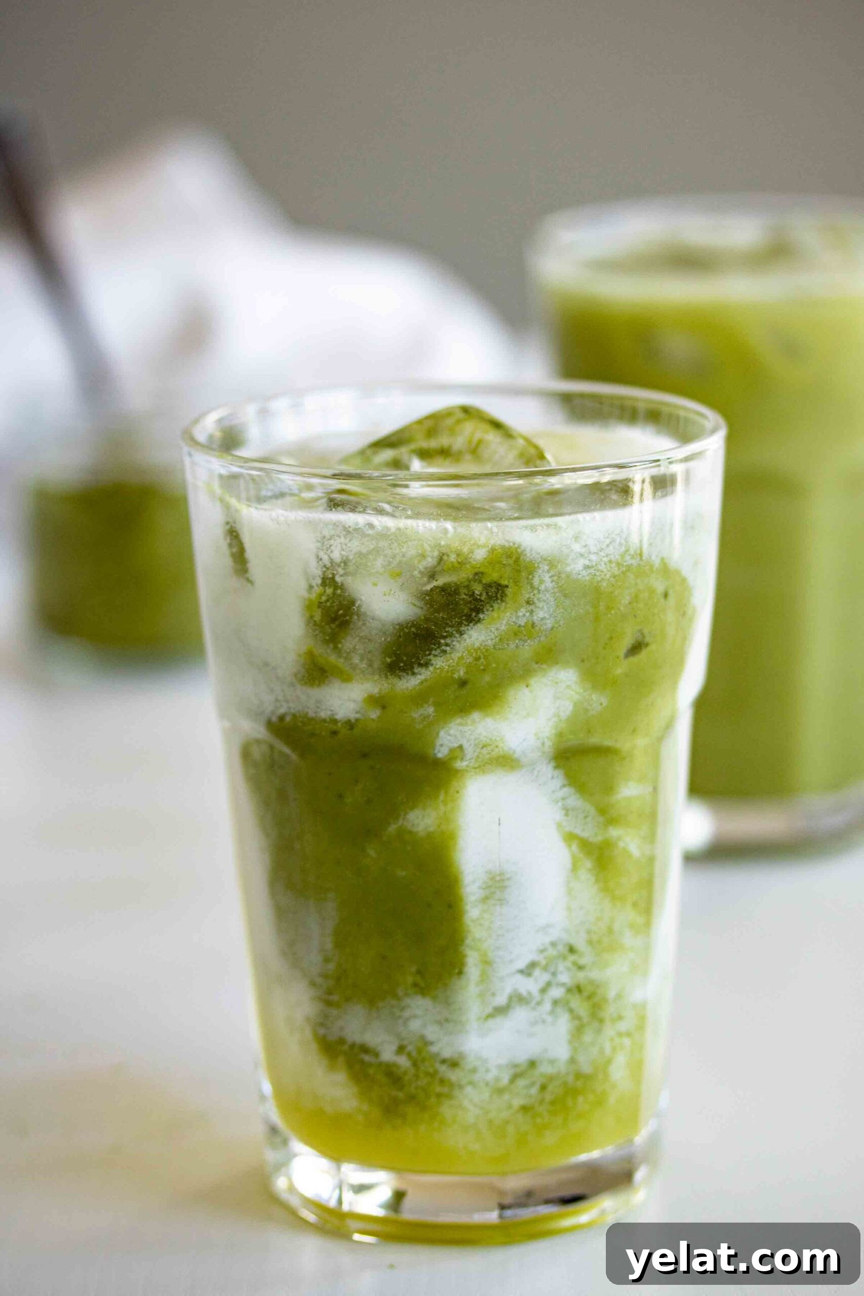 Close up on a glass full with matcha pineapple drink