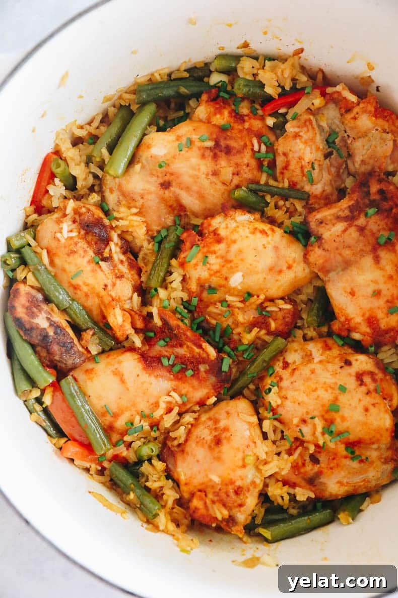 one pot chicken and rice in a white dutch oven.