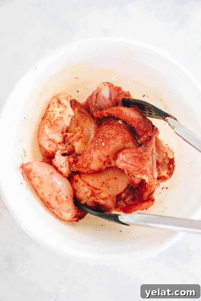 marinated chicken thighs in a white bowl