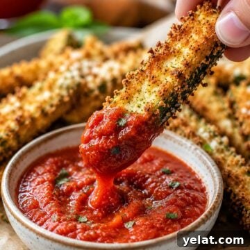 Crispy golden air fryer zucchini fries coated in parmesan panko breadcrumbs served with marinara dipping sauce