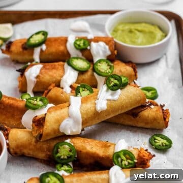 Chicken flautas with sour cream and jalapenos.