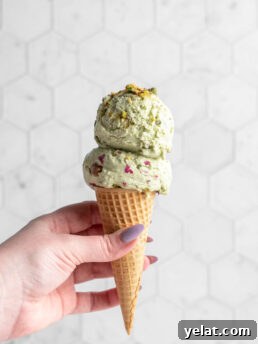 pistachio ice cream scoops in a cone